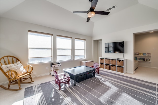 carpeted living room featuring plenty of natural light, ceiling fan, and vaulted ceiling