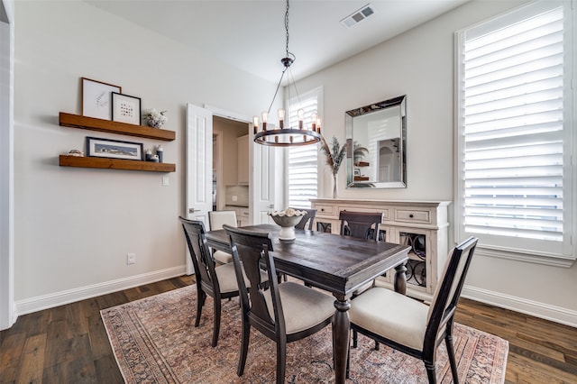 dining space featuring a chandelier and dark hardwood / wood-style flooring