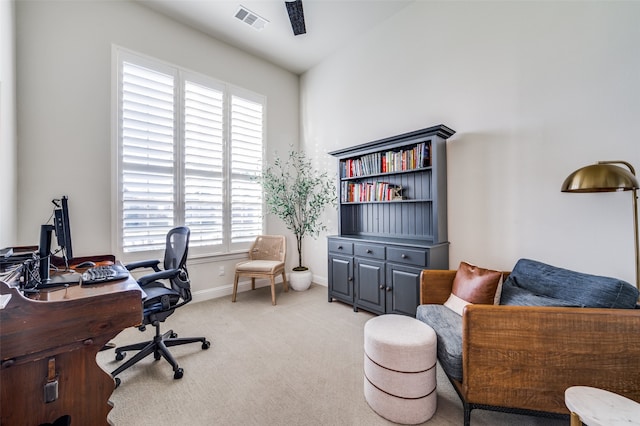 carpeted home office featuring lofted ceiling