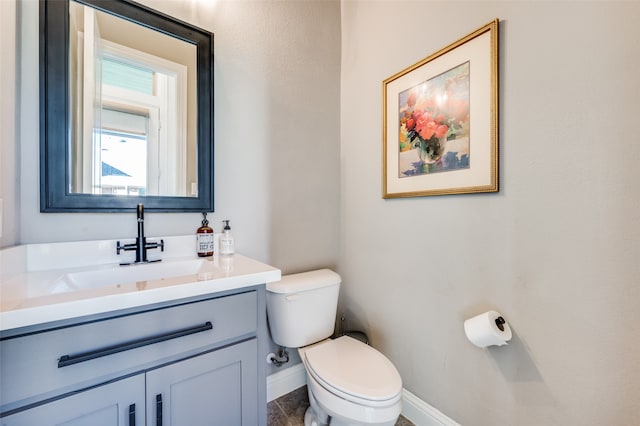 bathroom featuring tile patterned flooring, vanity, and toilet