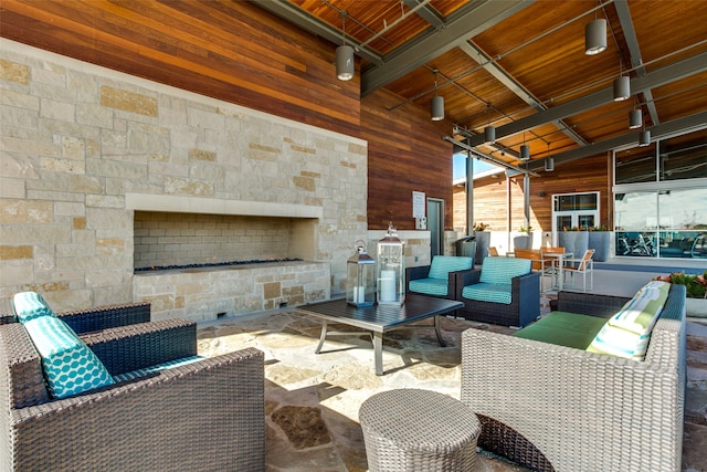 view of patio featuring an outdoor stone fireplace