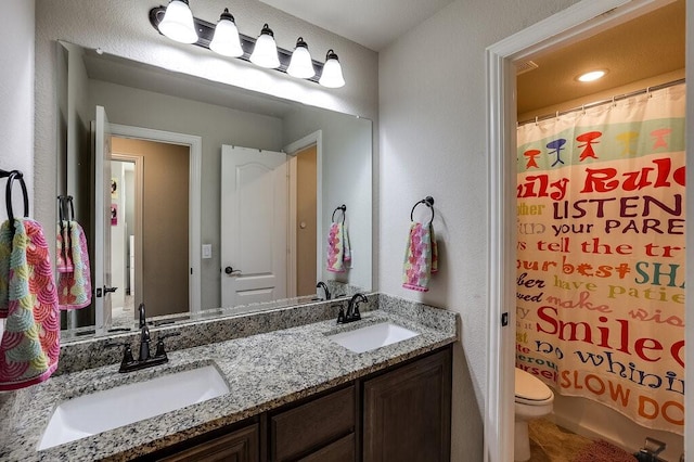 bathroom featuring vanity and toilet