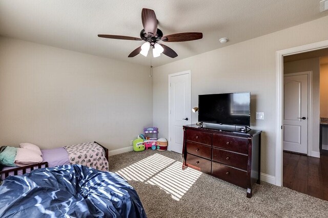 bedroom featuring ceiling fan and dark hardwood / wood-style flooring