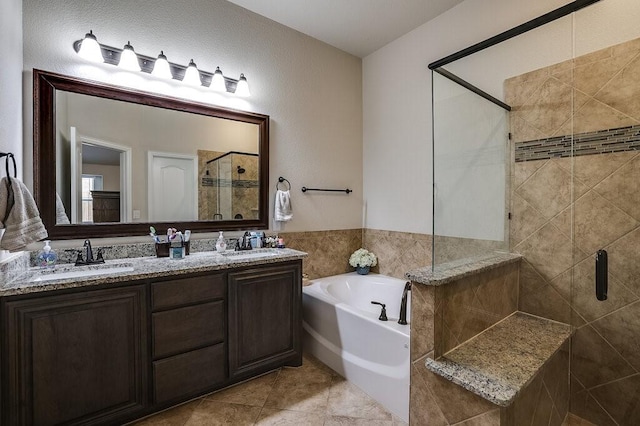 bathroom with tile patterned flooring, vanity, and independent shower and bath