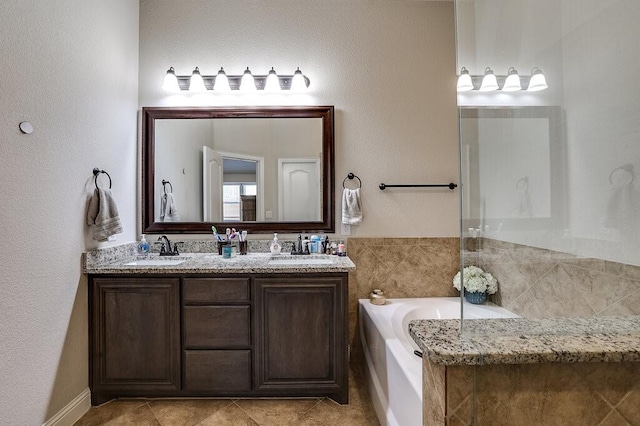 bathroom with vanity, tile patterned floors, and a tub