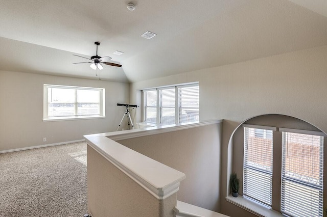 hall with lofted ceiling, carpet floors, and a healthy amount of sunlight