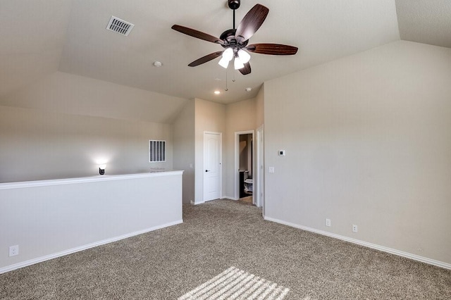 carpeted spare room with ceiling fan and lofted ceiling