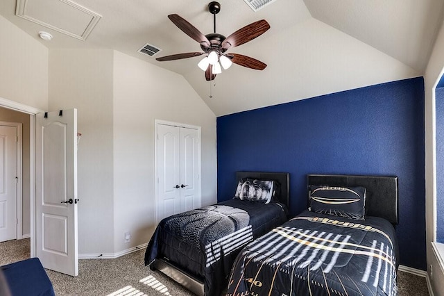 carpeted bedroom featuring a closet, vaulted ceiling, and ceiling fan