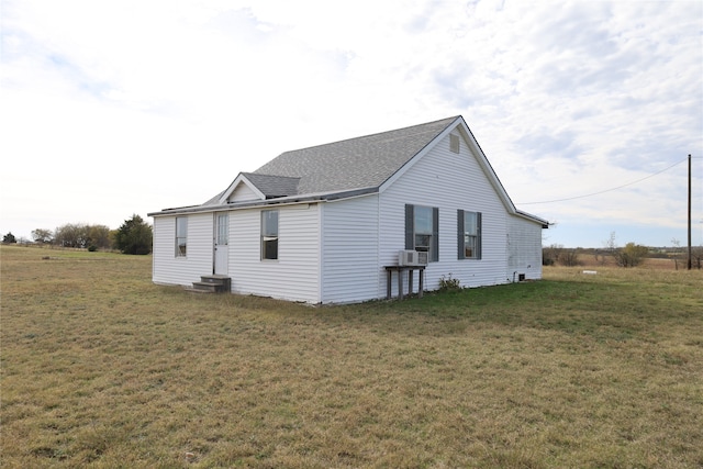 view of home's exterior featuring a yard and cooling unit