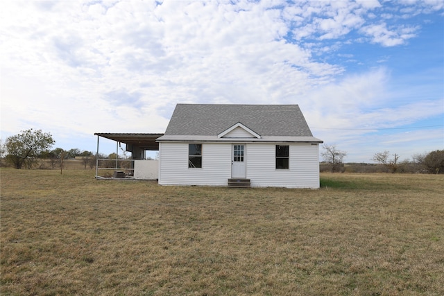 view of front facade with a carport and a front yard