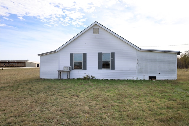 rear view of property with a yard