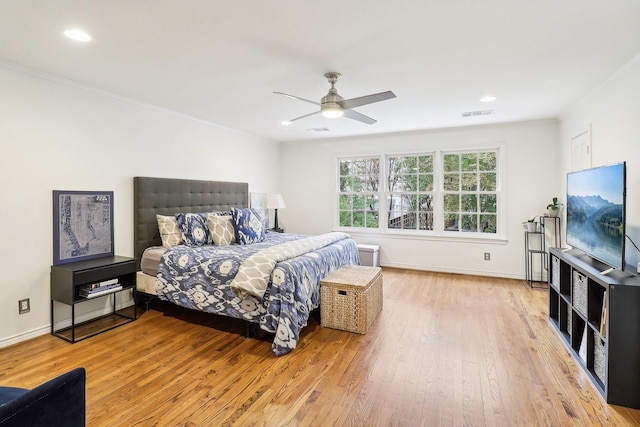 bedroom with light hardwood / wood-style floors and ceiling fan