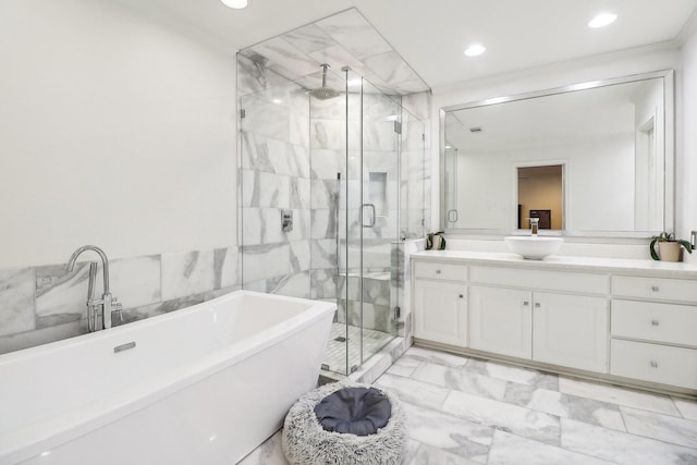 bathroom with vanity, tile walls, and separate shower and tub