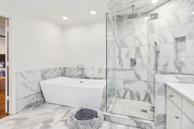 bathroom featuring tile walls, vanity, and independent shower and bath