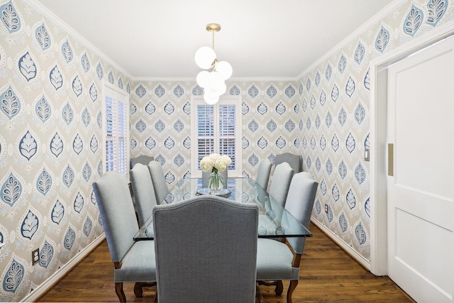 dining space featuring dark wood-type flooring, ornamental molding, and a chandelier