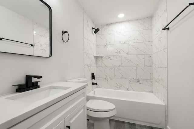 full bathroom with vanity, toilet, and tiled shower / bath