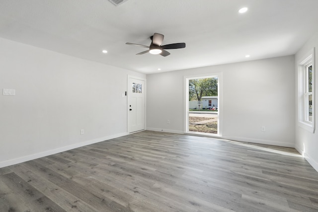 unfurnished room with hardwood / wood-style floors and ceiling fan