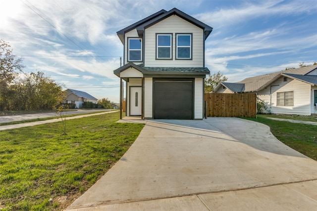 view of front of property with a garage and a front lawn