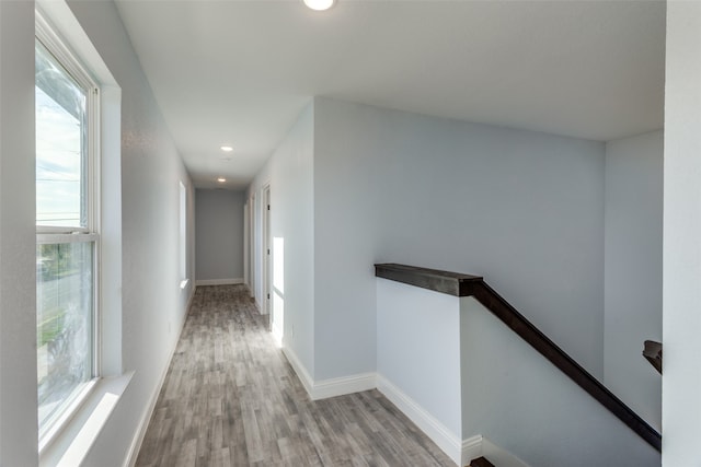 corridor with light hardwood / wood-style floors