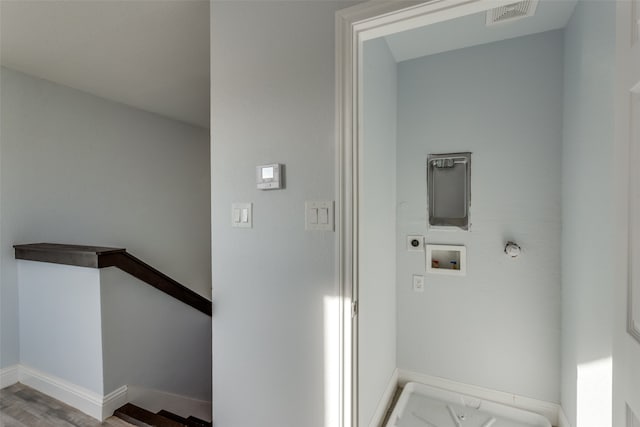 clothes washing area featuring gas dryer hookup, hardwood / wood-style floors, washer hookup, and hookup for an electric dryer