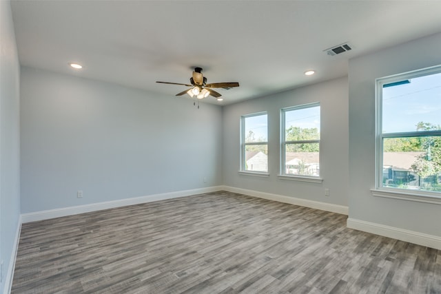 spare room with ceiling fan and light wood-type flooring