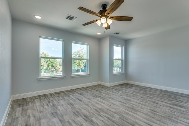 spare room featuring ceiling fan and light hardwood / wood-style floors