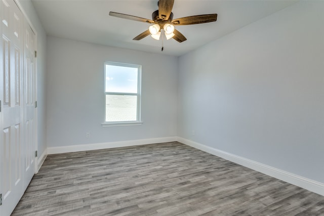 empty room featuring light wood-type flooring and ceiling fan