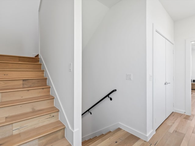 stairs featuring wood-type flooring