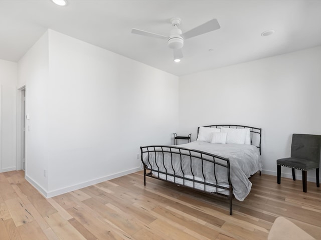 bedroom with ceiling fan and wood-type flooring