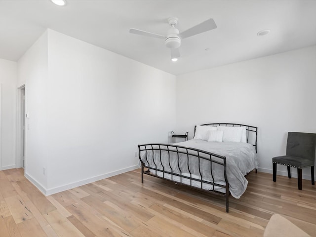 bedroom with hardwood / wood-style flooring and ceiling fan