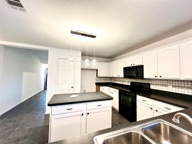 kitchen with pendant lighting, sink, black appliances, white cabinets, and decorative backsplash