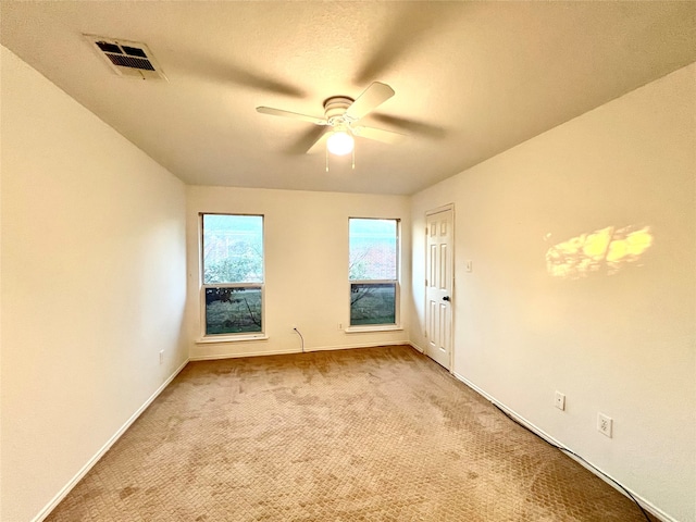 carpeted empty room with ceiling fan