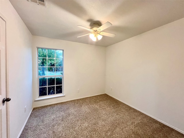 carpeted spare room with ceiling fan