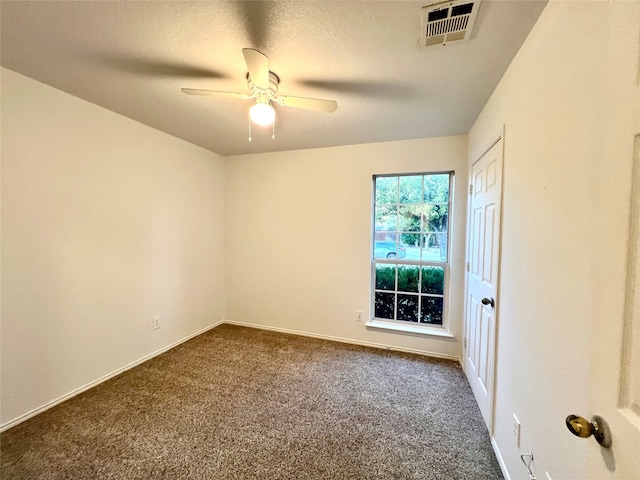 carpeted spare room with a textured ceiling and ceiling fan