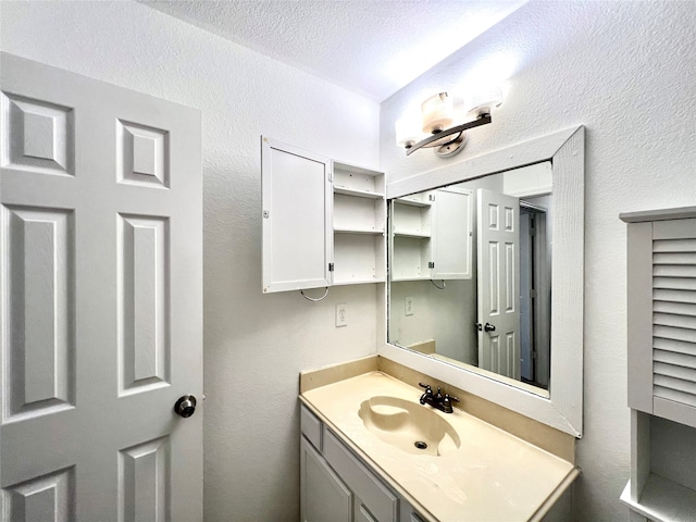 bathroom featuring vanity and a textured ceiling