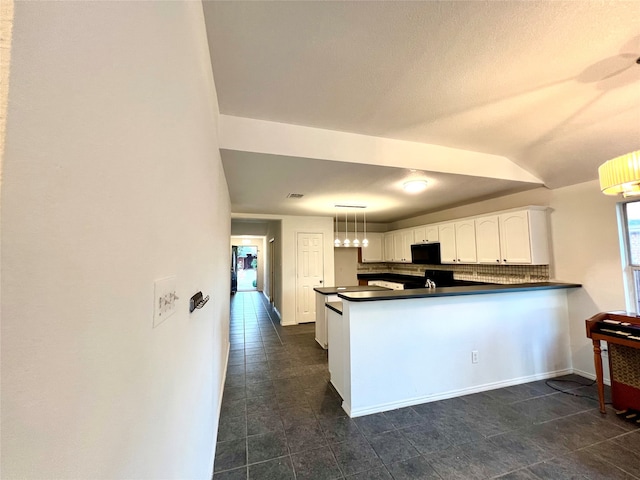 kitchen featuring white cabinetry, backsplash, kitchen peninsula, and pendant lighting