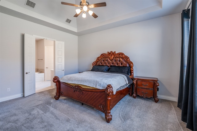 bedroom with carpet, a raised ceiling, and ceiling fan