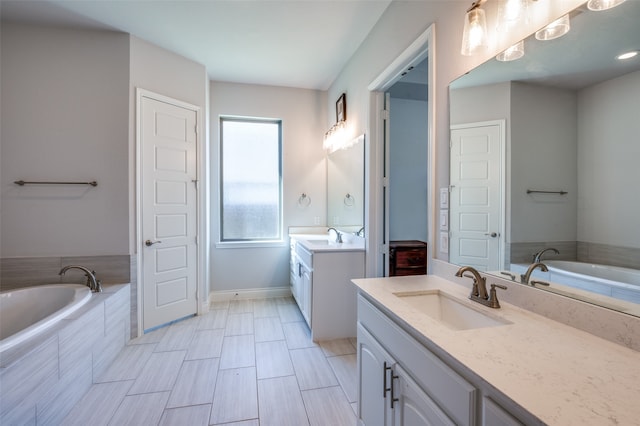 bathroom featuring vanity and a relaxing tiled tub