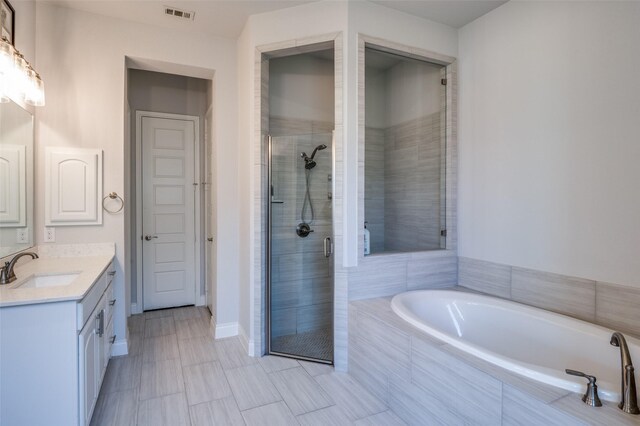 bathroom with vanity and plus walk in shower