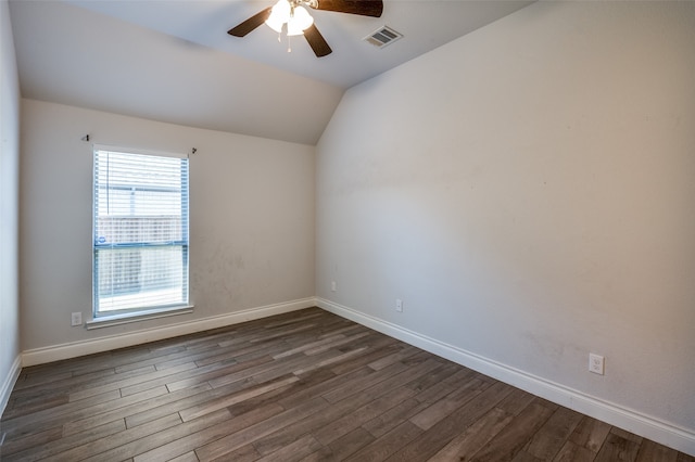 empty room with ceiling fan, dark wood-type flooring, and vaulted ceiling