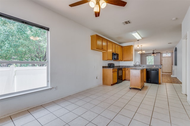 kitchen with kitchen peninsula, sink, black appliances, hanging light fixtures, and light tile patterned flooring