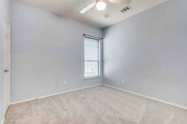 empty room with ceiling fan and light carpet