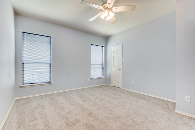 carpeted empty room featuring ceiling fan and a healthy amount of sunlight