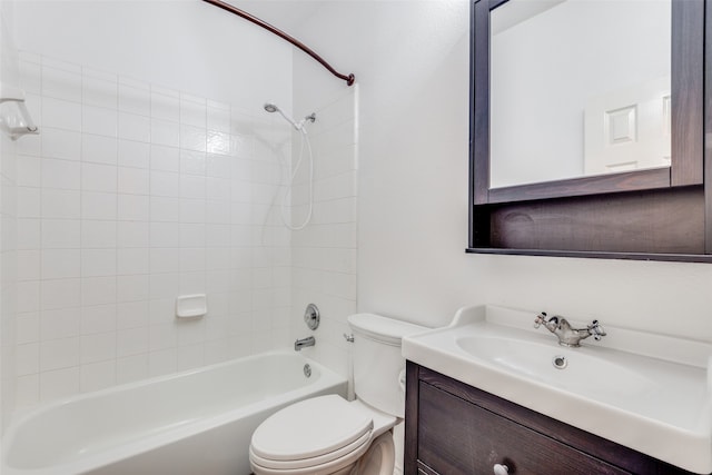 full bathroom with vanity, tiled shower / bath combo, and toilet