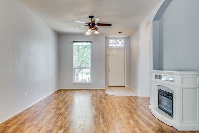 unfurnished living room with light hardwood / wood-style floors and ceiling fan