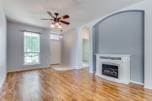 unfurnished living room with ceiling fan and light hardwood / wood-style floors