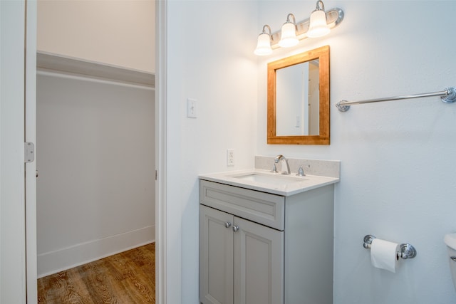 bathroom featuring hardwood / wood-style floors, vanity, and toilet