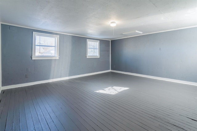 empty room featuring wood-type flooring and ornamental molding