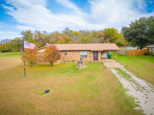 ranch-style home featuring a front yard and a carport