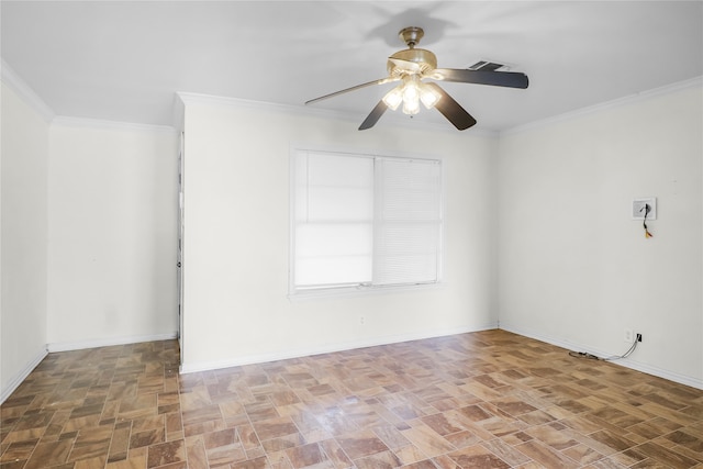 empty room featuring ceiling fan and crown molding